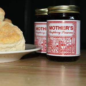 2 small bottles of raspberry preserve and bread